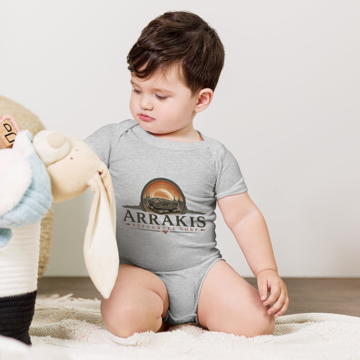 Baby bodysuit with a fictional mining company logo for Arrakis Resources Corp