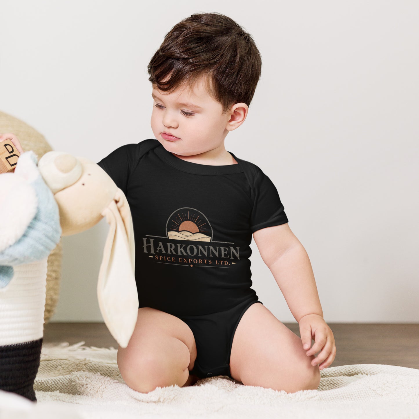 Baby bodysuit with a fictional trading company logo for Harkonnen Spice Exports Ltd