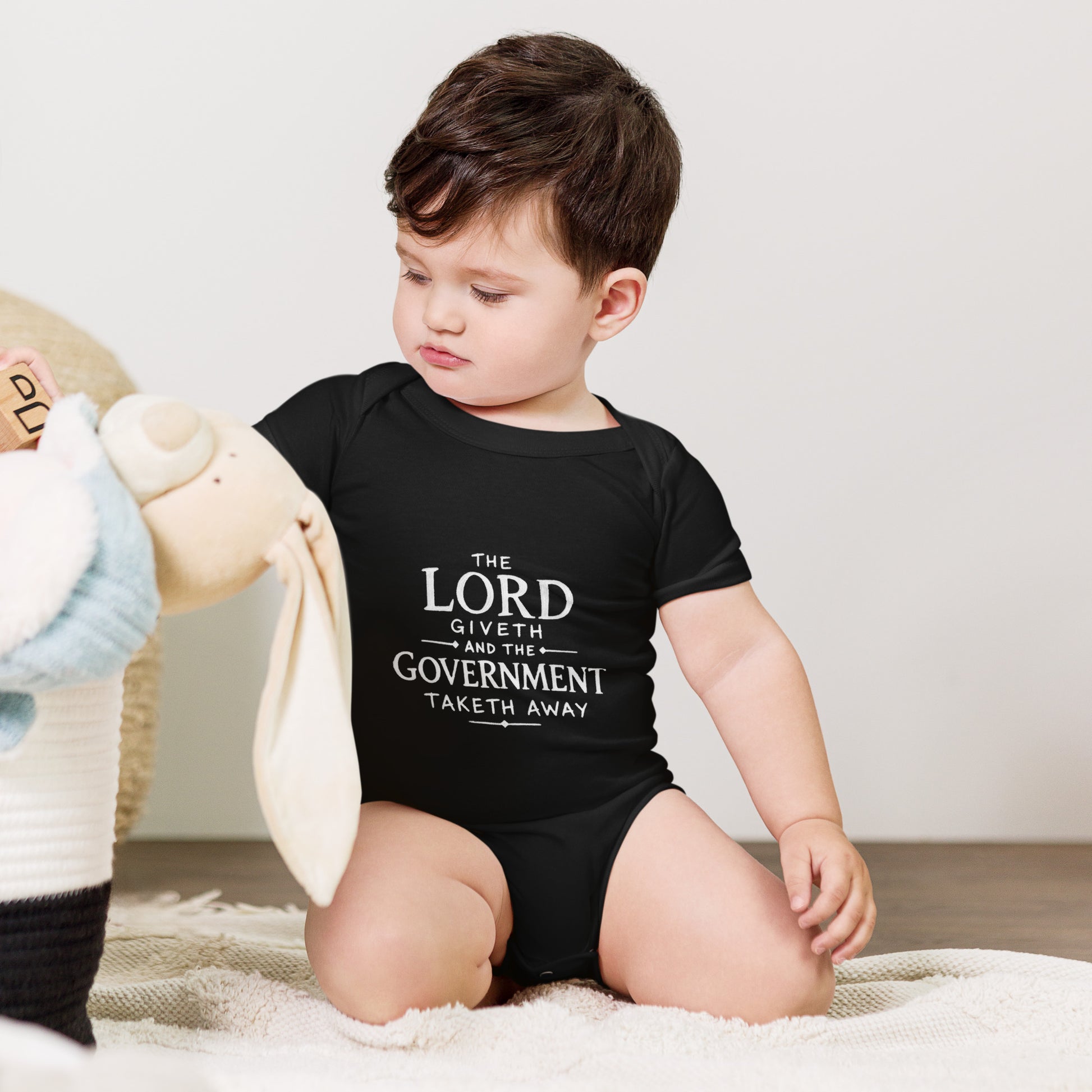 Baby bodysuit with the words The Government Taketh Away