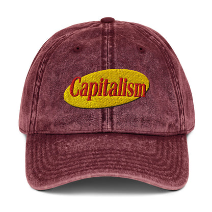 "Capitalism" in retro sitcom-style lettering on a vintage washed cotton twill cap