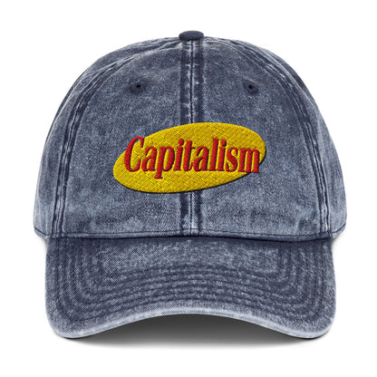 "Capitalism" in retro sitcom-style lettering on a vintage washed cotton twill cap